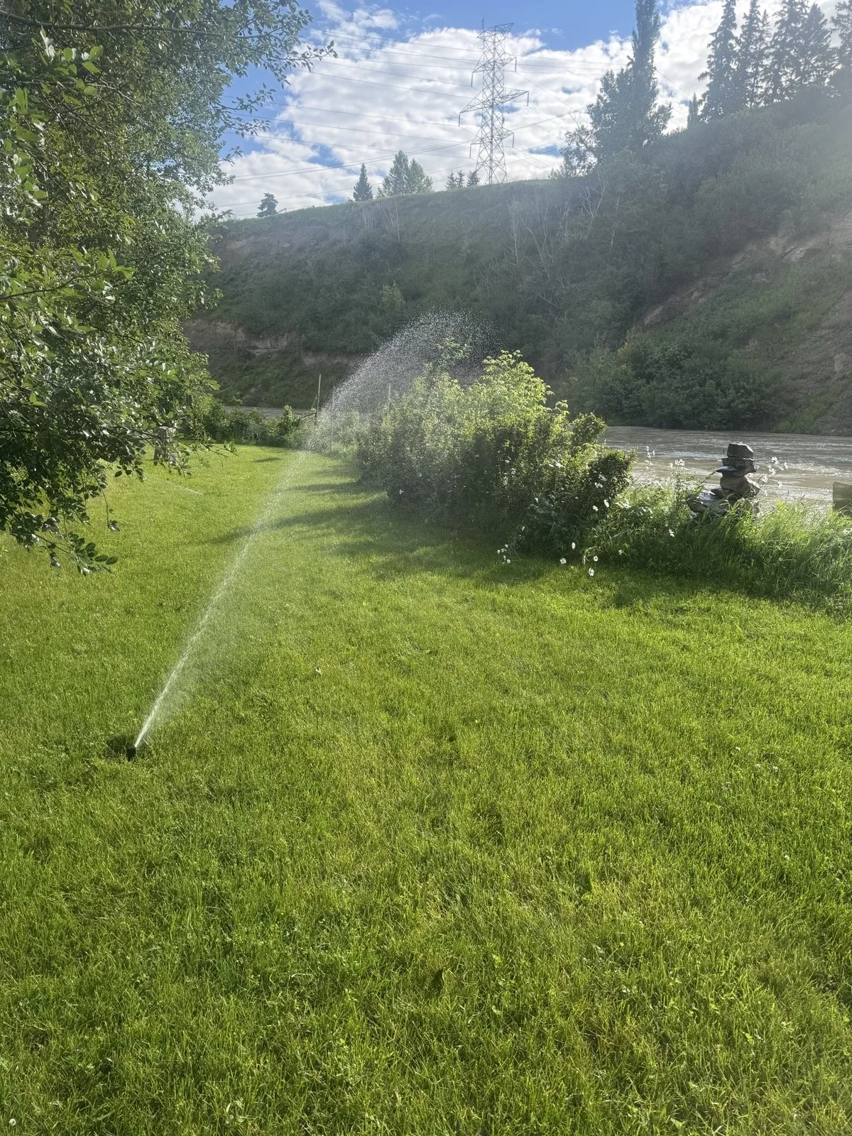 The same rotor zone mid-rotation, covering a big lawn edge to edge