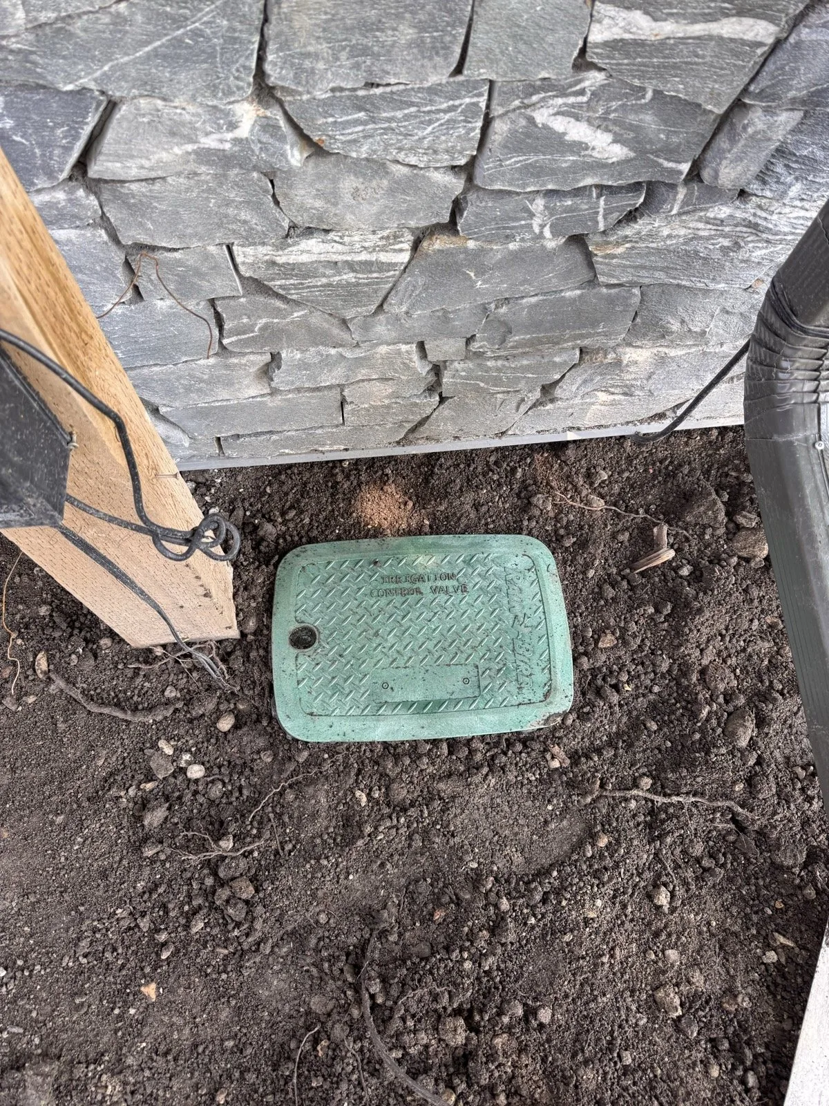 A valve box set flush in the soil